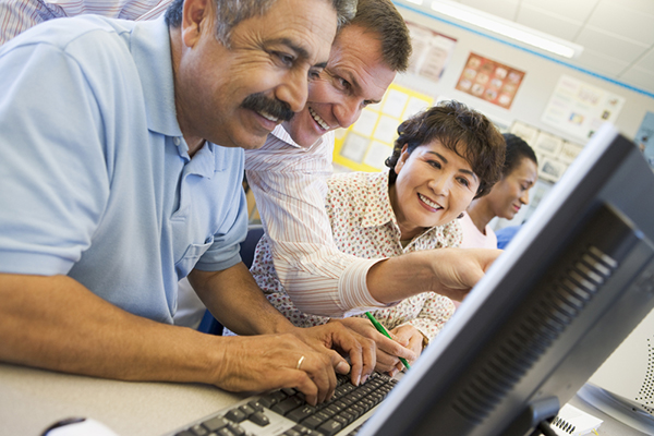 adult studenst at a computer