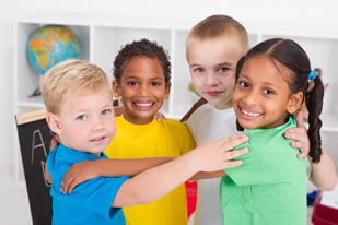 four school kids hugging