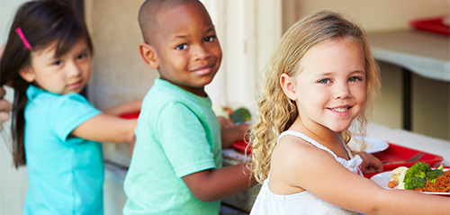 three kids in line in cafeteria